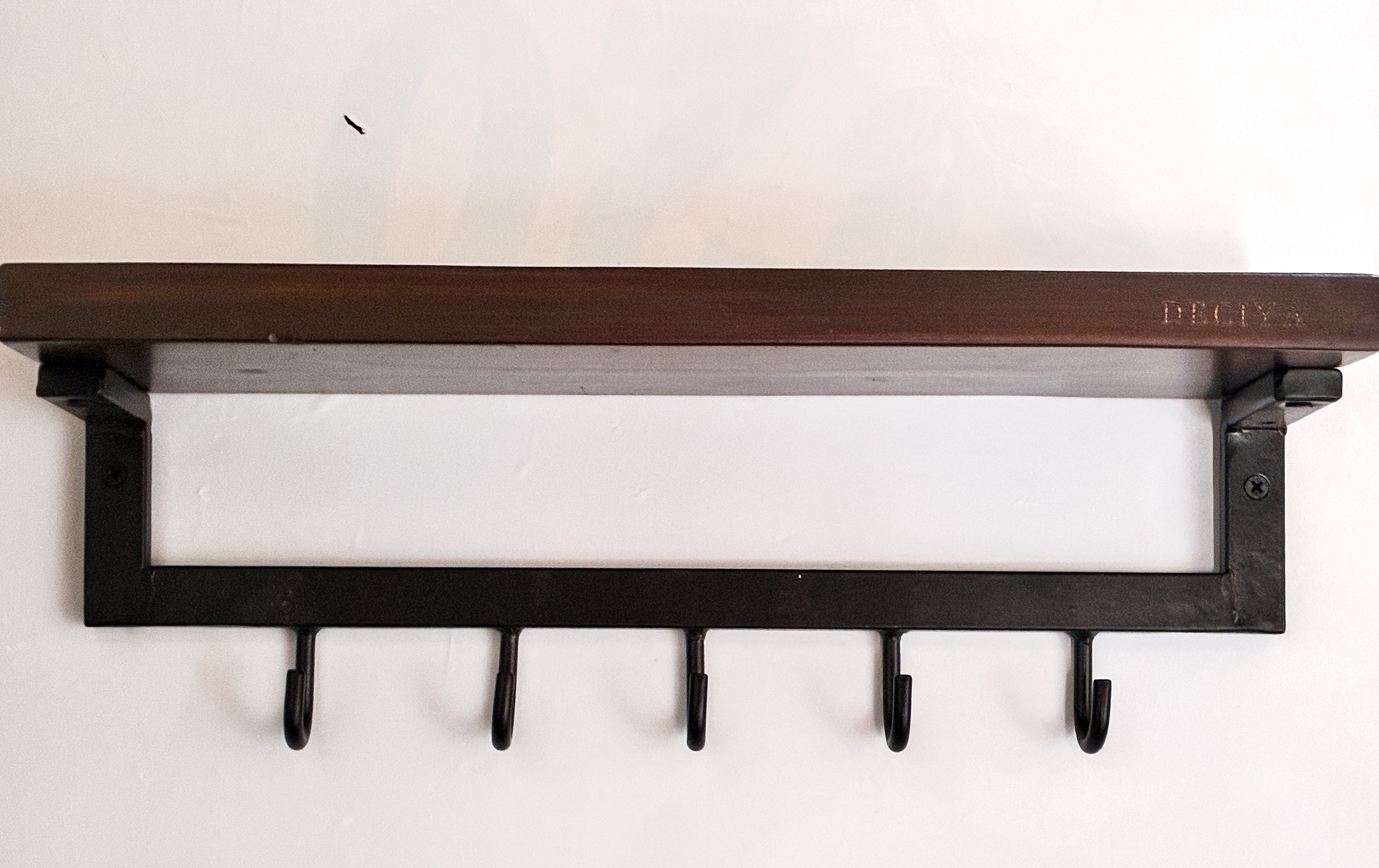 KeyDock mounted on wall with keys hanging from matte black steel hooks